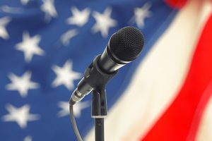 Microphone in front of an American flag