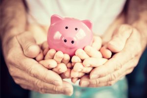 Hands holding a piggybank