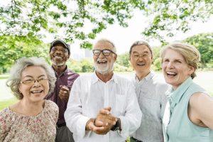 Image of five senior friends laughing, suggesting that they are aging gracefully