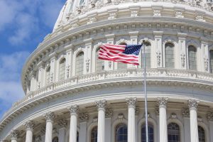 Image of the American flag outside of the capitol dome