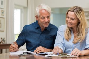 Image of a middle-aged couple managing their investments stress-free