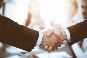 Image of two businessmen making a handshake guarantee