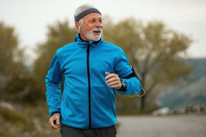 Image of a jogging senior man about to take a leap