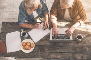 Image of a senior couple doing business online