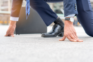 Image of a businessman poised for the start of a race