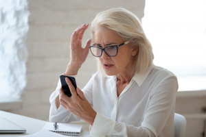 Image of a frustrated woman calling her bank suspecting financial scams