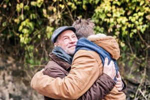 Image of a father hugging his adult son