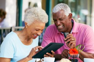 Image of a senior couple checking on their finances online