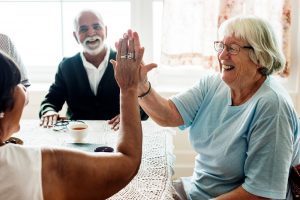 Image of two senior women giving each other a high-five