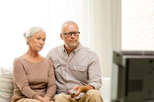 Image of a senior couple watching the news