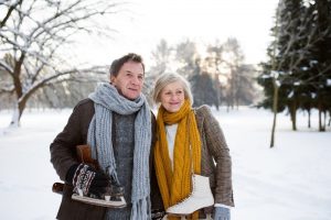 Image of two seniors walking in the snow