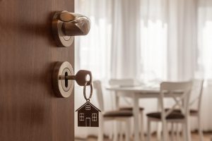 Image of an open door with a house key in it, representing a mortgage