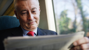 Image of a pleased investor reading the newspaper