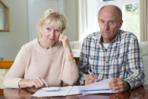 Image of a concerned senior couple calculating their portfolio’s beta