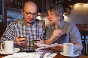 Image of a senior couple checking for financial fraud