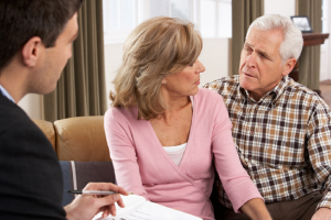 Image of a senior couple speaking to their financial advisor