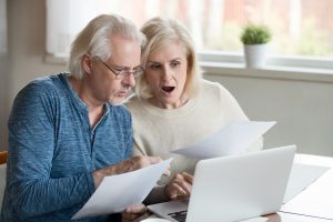 Image of a worried senior couple monitoring the stock market