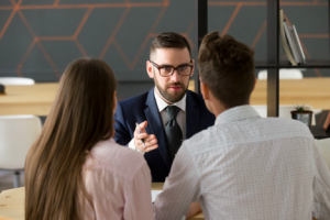 Image of a broker pitching a young couple