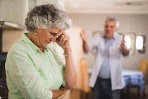 Image of a senior woman looking frustrated as her friend yells