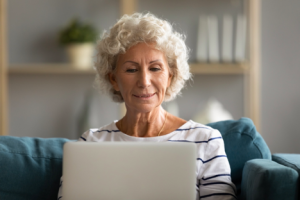 Image of a pleased senior woman using her computer