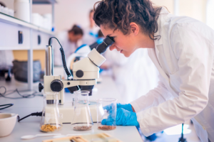 Image of a scientist using a microscope