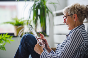 Image of a senior woman day trading on her tablet