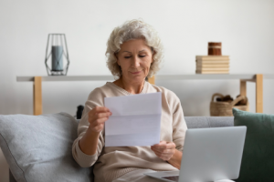 Image of a senior woman reading a list