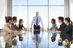 Image of a CEO discussing stock buybacks with his team