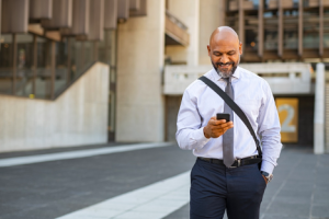 Image of a businessman surfing the web on his cell phone