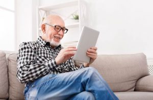 Image of a pleased senior man reading