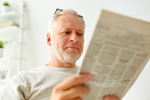 Image of a senior man reading the newspaper