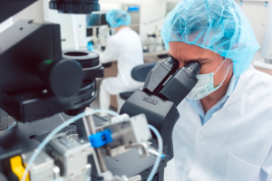 Image of a medical researcher at their microscope