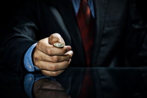 Image of a businessman flipping a coin