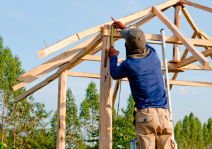 Image of a man building a house