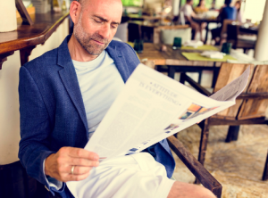 Image of a senior man reading the newspaper