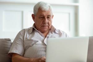 Image of an investor using a laptop to check on his stocks