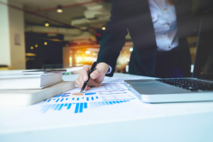 Image of an asset manager pointing to a chart