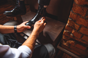 Image of a man giving another man a shoe shine