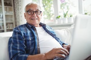 Image of a happy senior man using his laptop