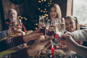 Image of a family around a table toasting their New Year’s Resolutions