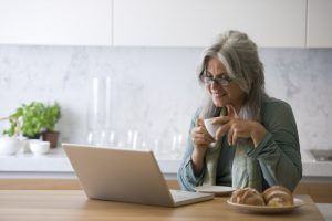 Image of a senior woman working on her laptop