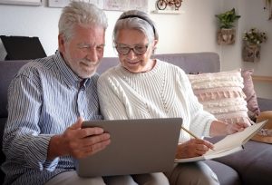 Image of a senior couple watching a video on their laptop