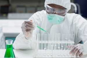 Image of a chemist filling test tubes