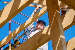 Image of a senior man building a house