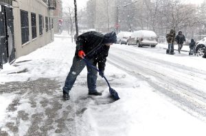 Image of a teen shoveling snow