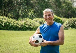 Image of a senior man holding a soccer ball