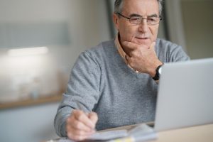 Image of a senior man using his laptop