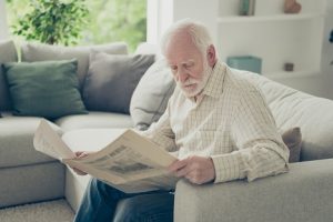 Image of a senior man reading a newspaper