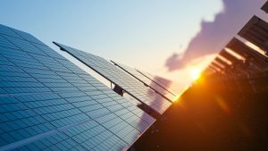 Image of the sun shining on solar panels