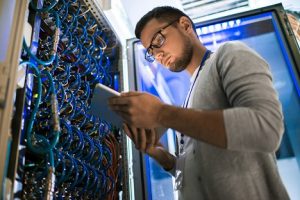 Image of a young man working in a server cabinet